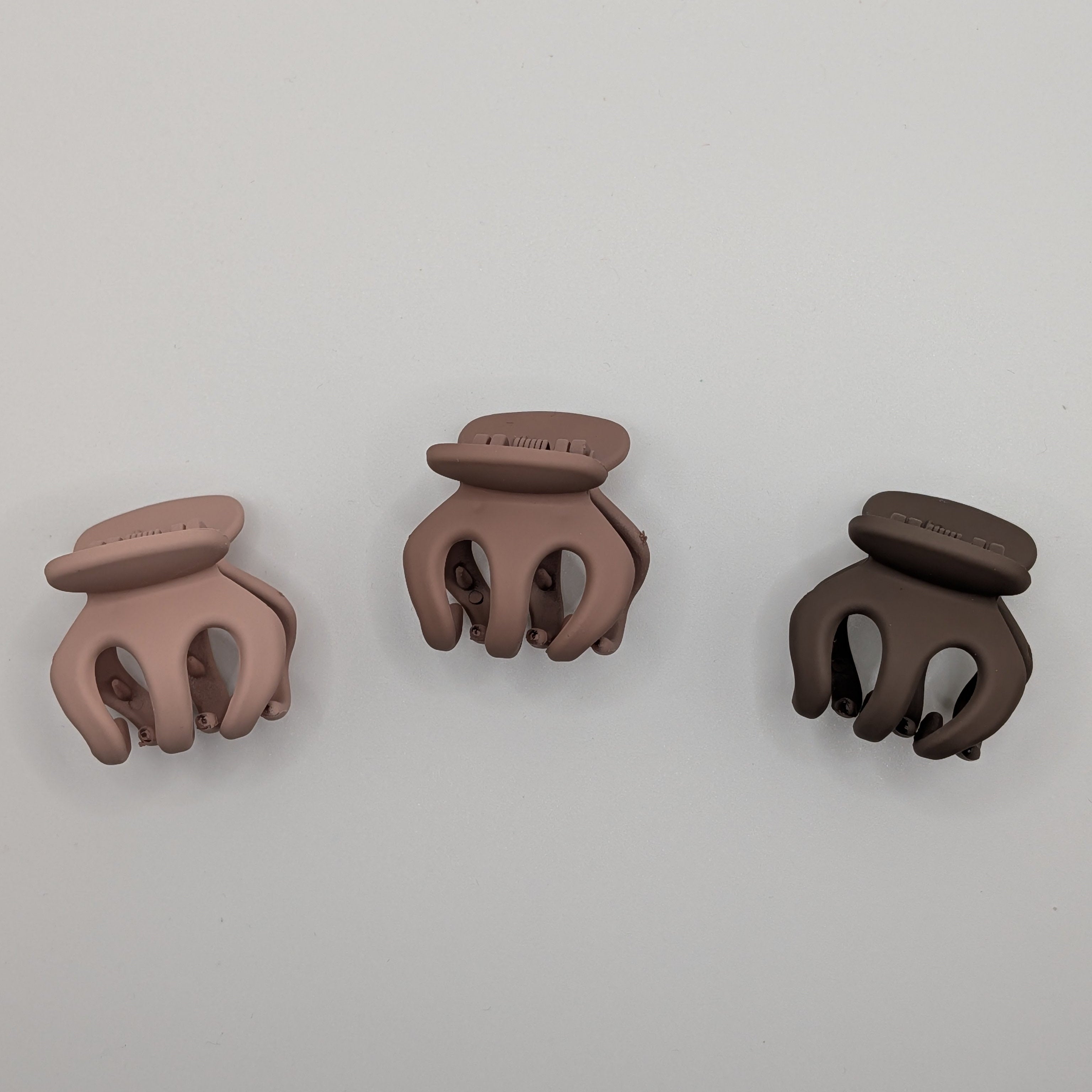 Top-down view of three 3cm rounded matte hair claw clips in a gradient of mauve and brown.

Draufsicht auf drei 3cm abgerundete matte Haarklammern in einem Verlauf von Mauve und Braun.